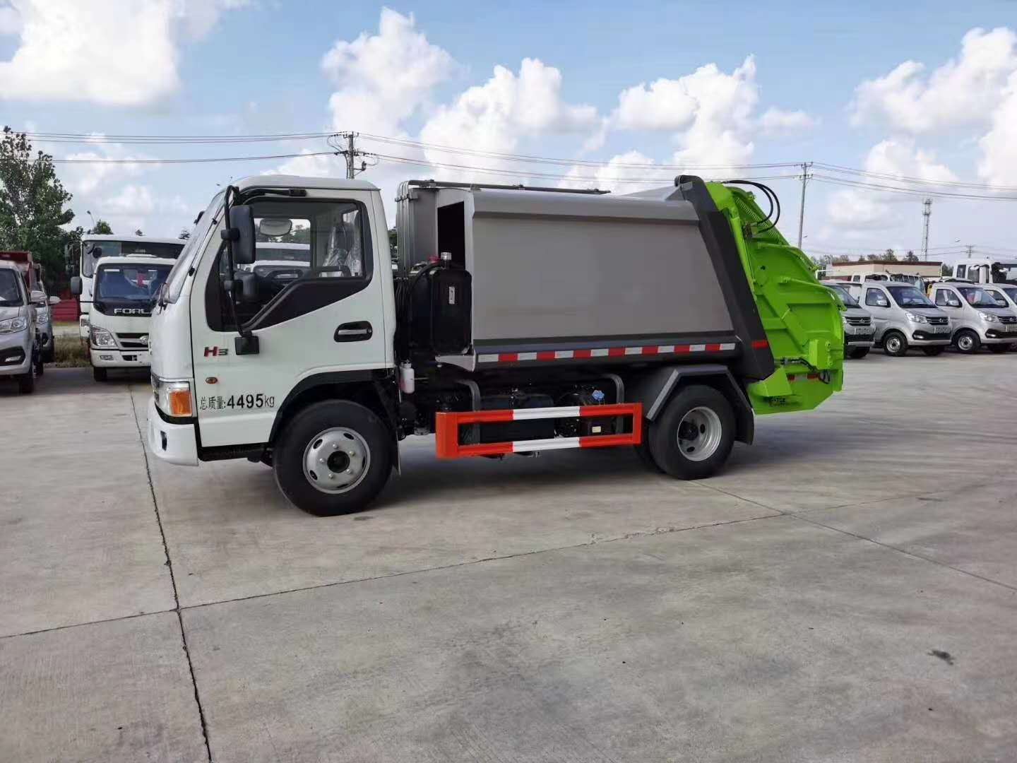 Side view of JAC light duty waste compactor