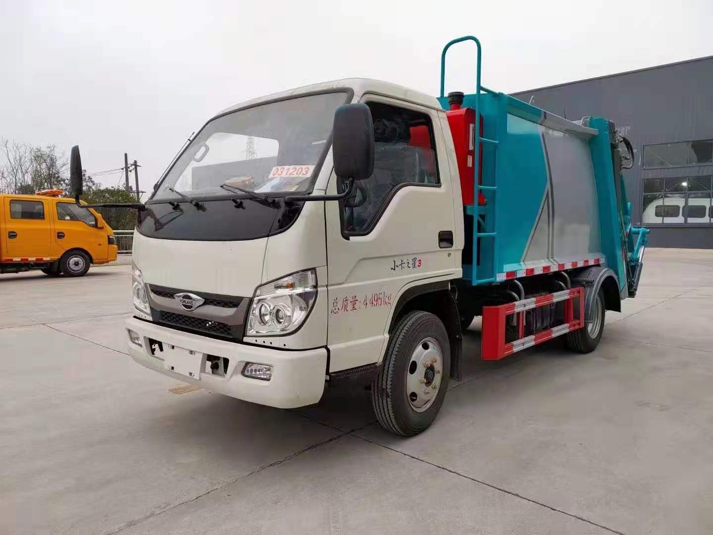Compact sanitation vehicle side view for narrow streets